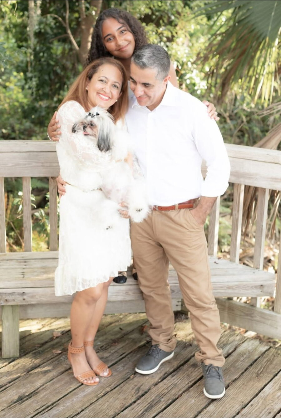 Anna and Floriano of Elegant Pet Mobile Spa with their family and a Shih Tzu